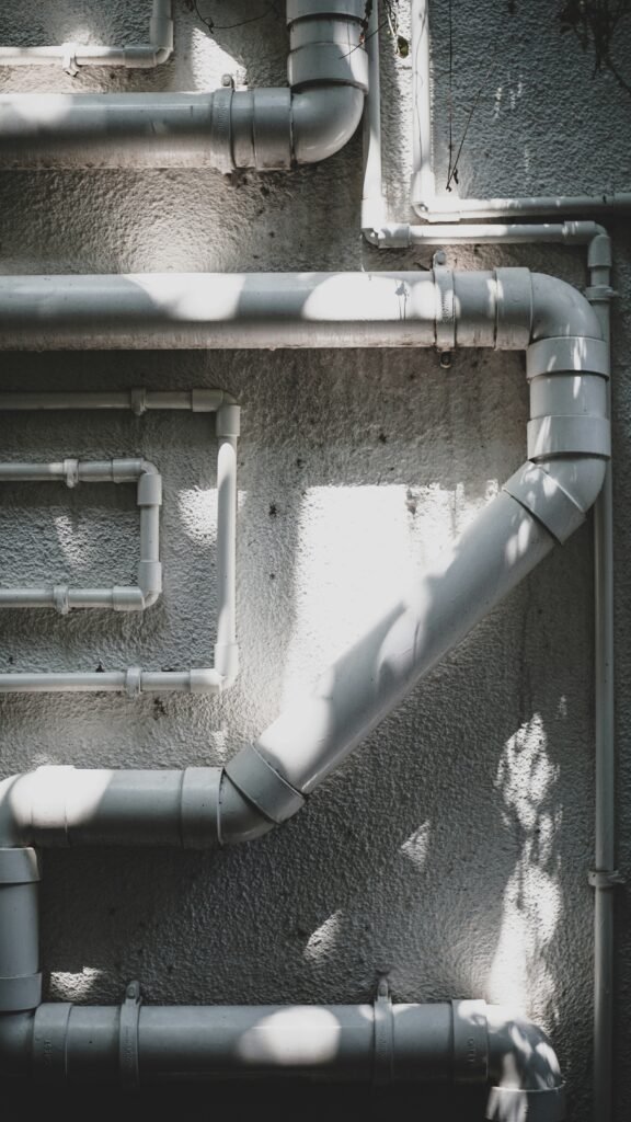 Cross-section of a home showcasing different pipe materials used throughout